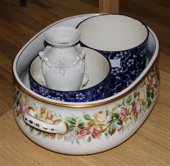 A floral footbath, a putti vase and a pair of planters